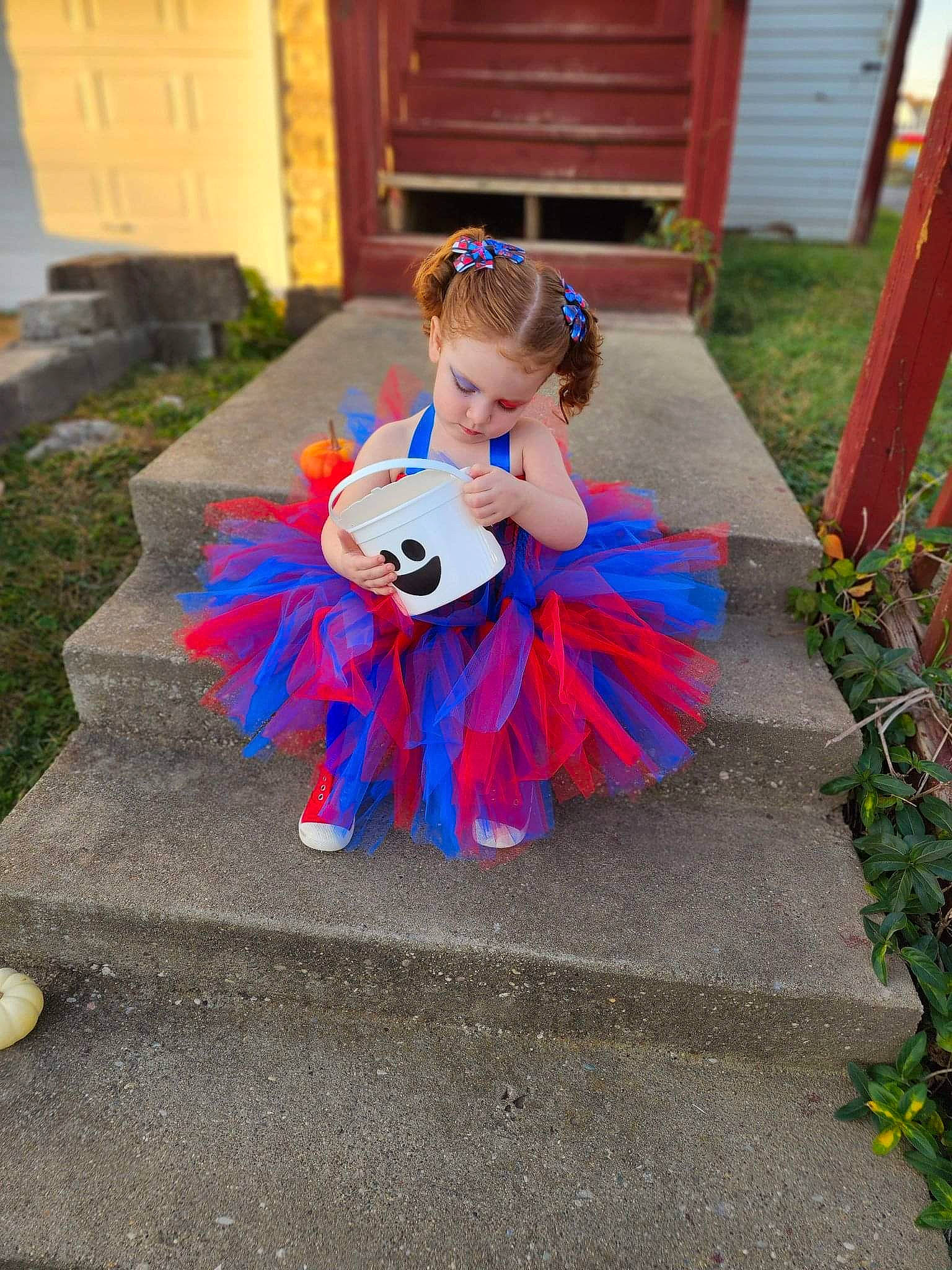 Rosemary joined the competition — help win amazing prizes! asphalt, child, electric_blue, event, fictional_character, flooring, garden, grass, lawn_ornament, person, petal, plant, pumpkin, recreation, road_surface, sidewalk, sitting, toddler, toy, wood