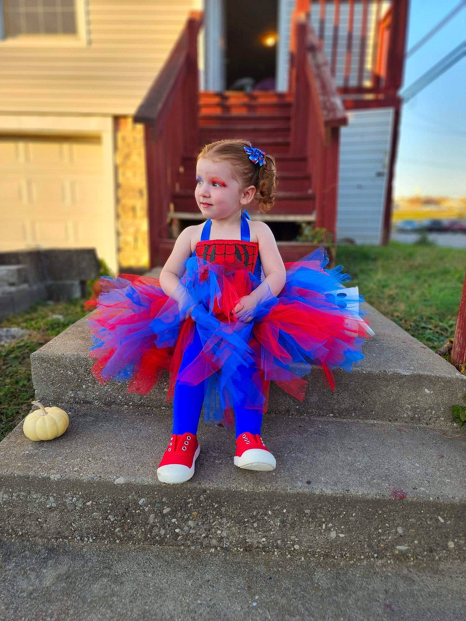 Rosemary is registered to the contest to win money with this photo: asphalt, child, costume, electric_blue, event, fictional_character, fun, grass, happy, hat, leisure, party_supply, person, plant, recreation, road, road_surface, sitting, toddler, vacation