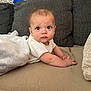 Jameson is registered to the contest to win money with this photo: arm, baby, blanket, child, clothing, couch, curious, expression, eyes, face, furniture, head, indoor, infant, looking, person, pillow, sitting, skin, soft