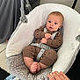 baby, baby_seat, blanket, carpet, child, clothing, comfort, curious, cute, face, foot, furniture, hand, indoor, infant, onesie, person, sitting, straps, toddler