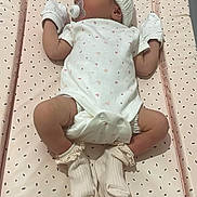 Antonia is registered to the contest to win money with this photo: baby, changing_pad, child, cozy, cute, diaper, gloves, hat, indoor, infant, newborn, onesie, pacifier, pattern, person, pink, resting, sleeping, socks, soft