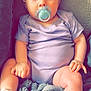 Antonia is registered to the contest to win money with this photo: baby, blanket, blue_eyes, child, clothing, cozy, cute, face, footwear, hand, indoors, infant, onesie, pacifier, portrait, seated, skin, socks, soft_texture, young