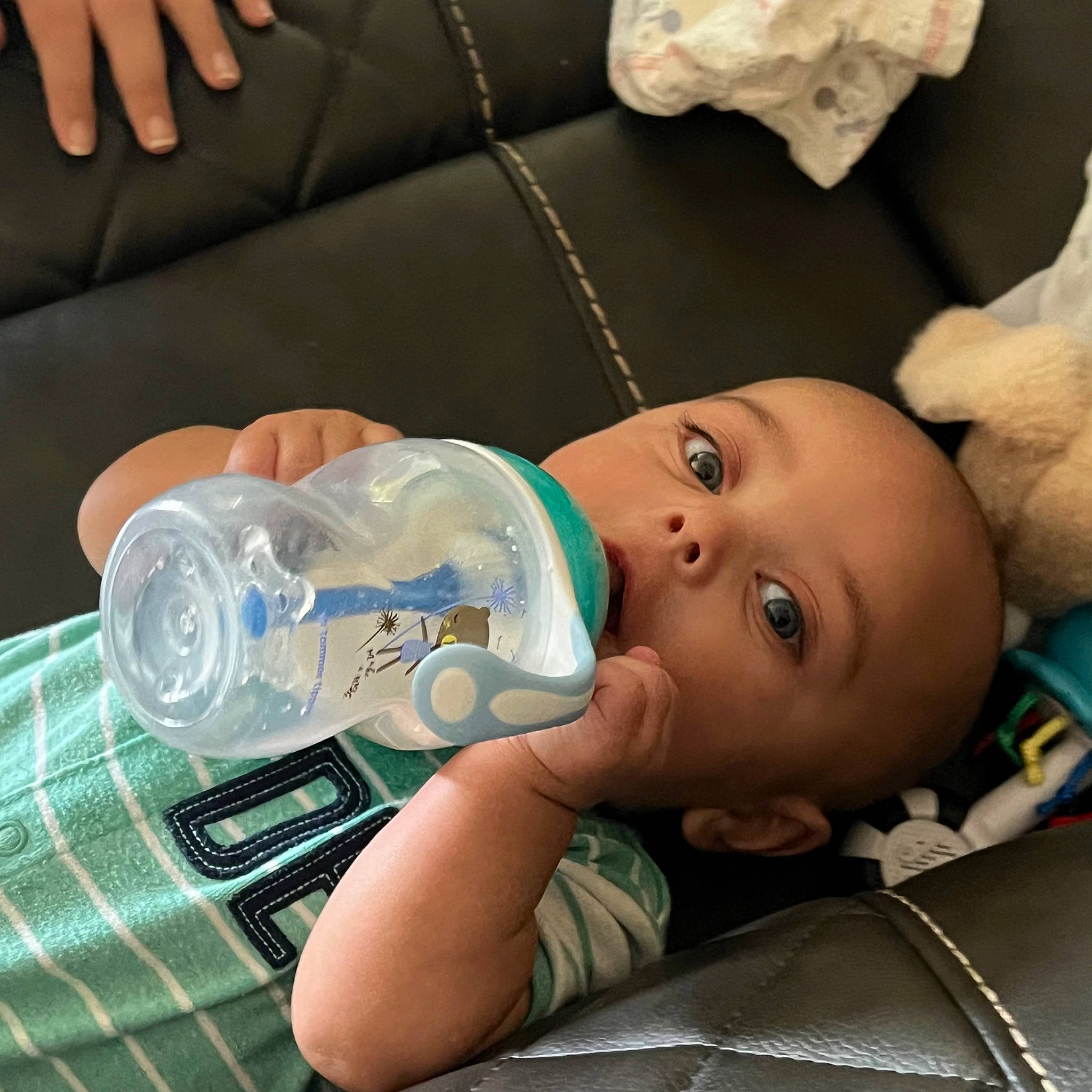 Dylane is registered to the contest to win money with this photo: baby, baby_products, baby_toddler_clothing, cheek, child, comfort, drinking_water, drinkware, elbow, head, linens, mouth, person, plaid, plastic, plastic_bottle, room, sitting, tartan, toddler