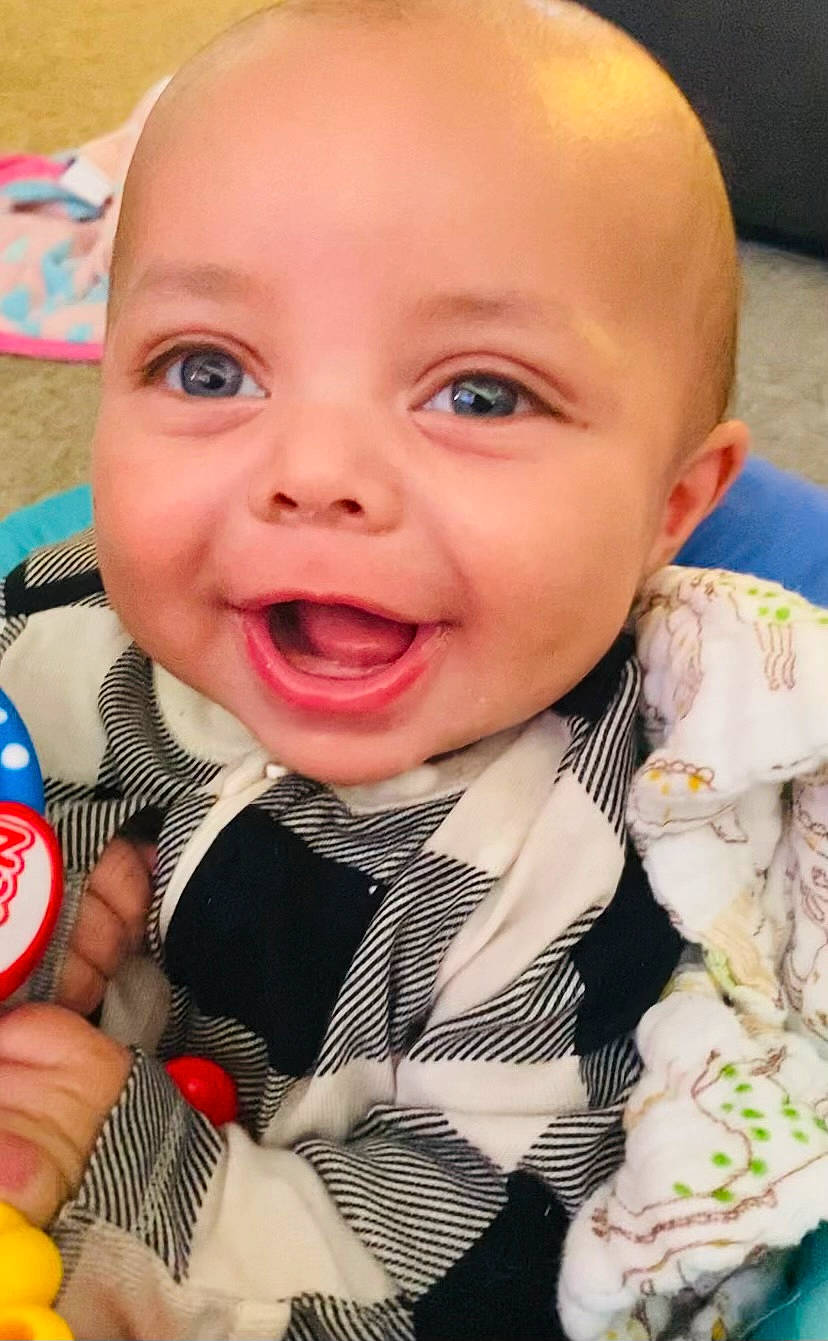 Dylane is registered to the contest to win money with this photo: baby, baby_products, baby_toddler_clothing, cheek, child, event, fun, happy, iris, laugh, lip, microphone, nose, pattern, person, pink, sitting, skin, smile, thumb