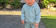 Tiago participe au concours pour gagner de l'argent avec cette photo : toddler, child, outdoor, garden, gravel, plants, flowers, hoodie, shorts, sneakers, curious, sunlight, greenery, patio, furniture, daylight, portrait, standing, moawk, casual