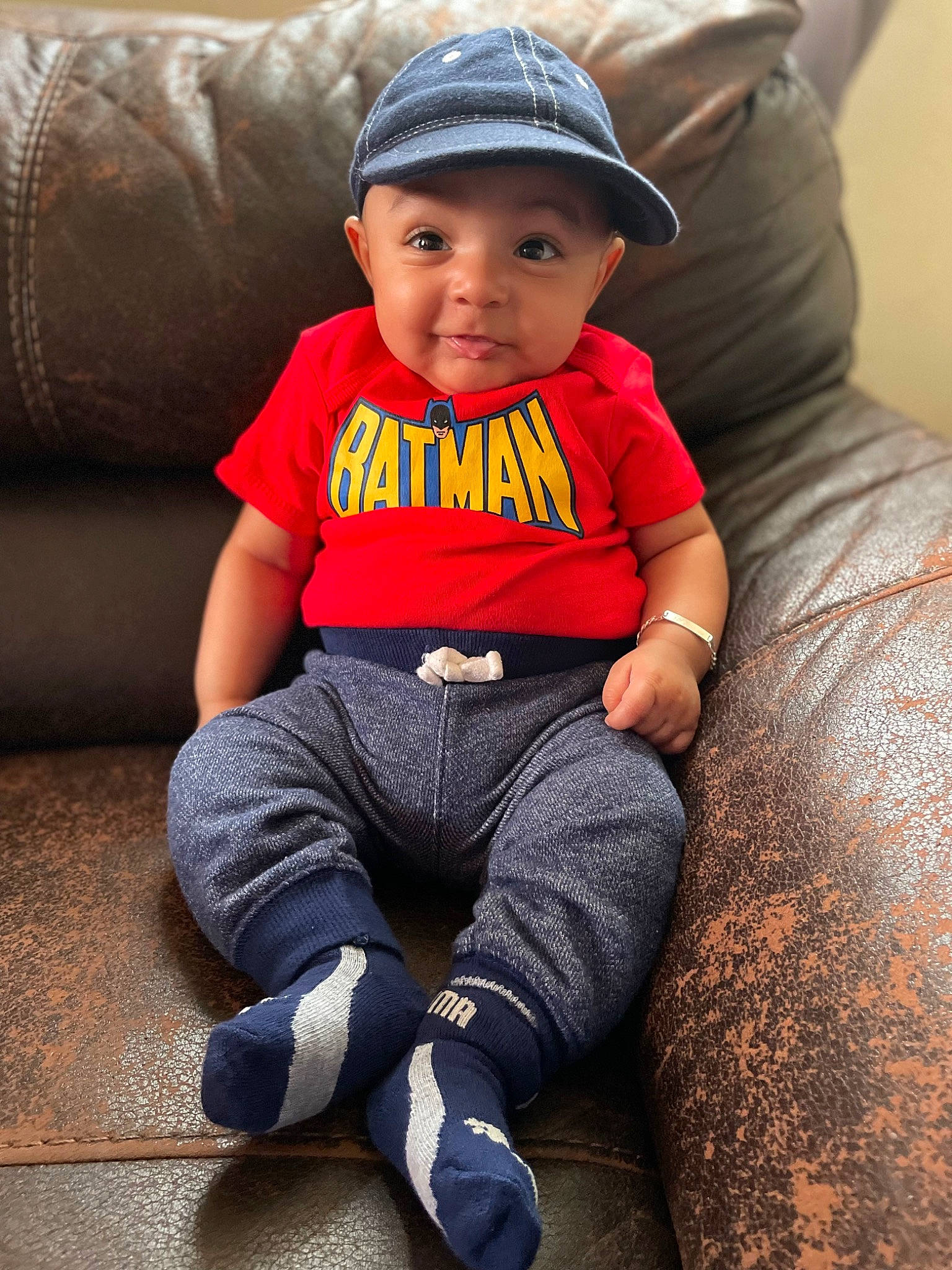 Elias Najjar joined the competition — help win amazing prizes! baby, baby_toddler_clothing, cap, child, comfort, cool, facial_expression, finger, flash_photography, happy, hat, headwear, human_leg, person, sitting, skin, sleeve, smile, t_shirt, thigh