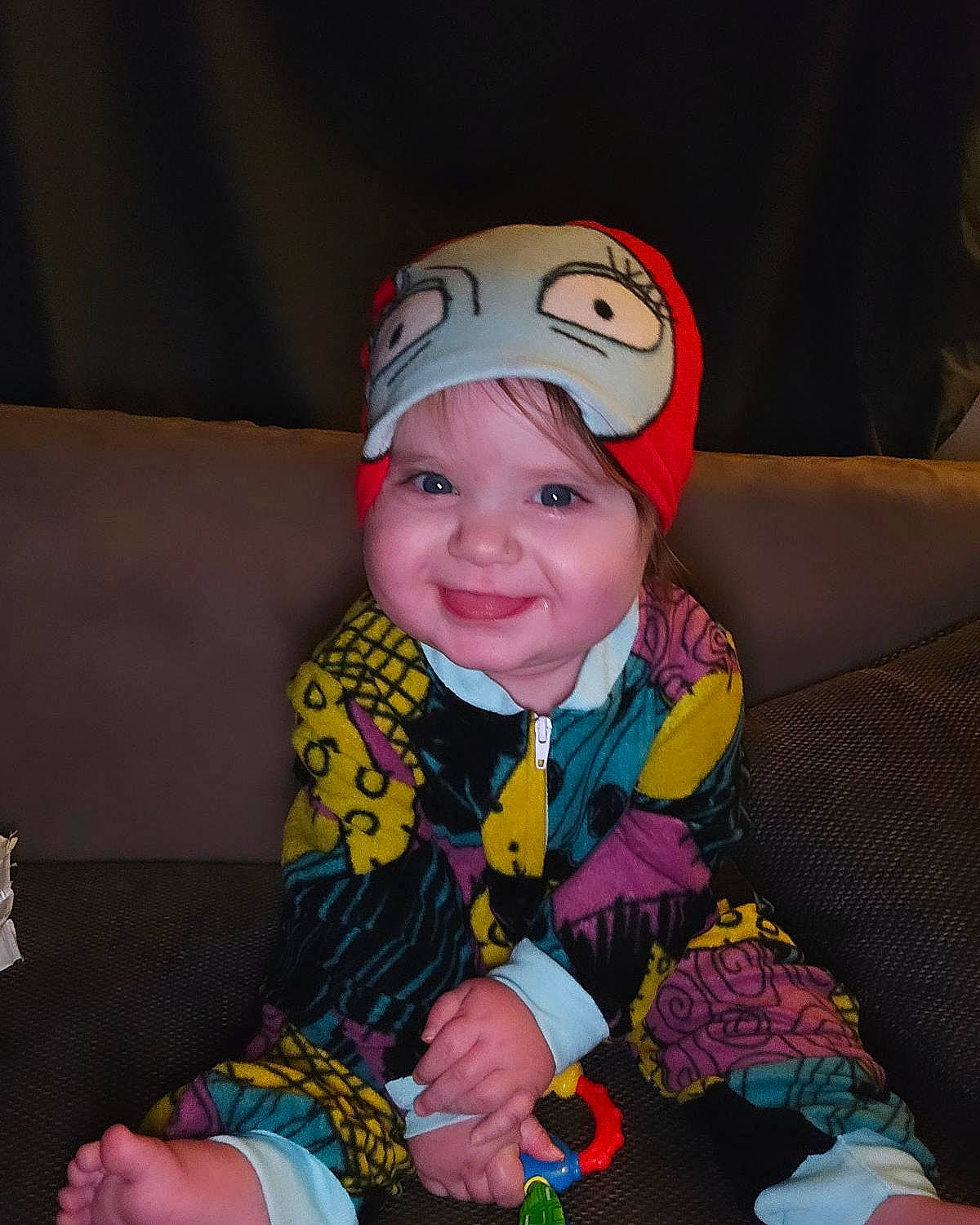 Everleigh is registered to the contest to win money with this photo: baby, baseballcap, bodypart, cap, clothing, coat, couch, face, furniture, happy, hat, head, indoors, interiordesign, jacket, person, photography, portrait, sitting, smile