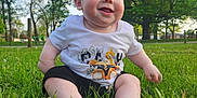 Ezra Ray joined the competition — help win amazing prizes! baby, child, cute, daytime, grass, greenery, happy, infant, nature, outdoor, park, playful, portrait, shorts, sitting, sky, smiling, sunlight, tree, tshirt