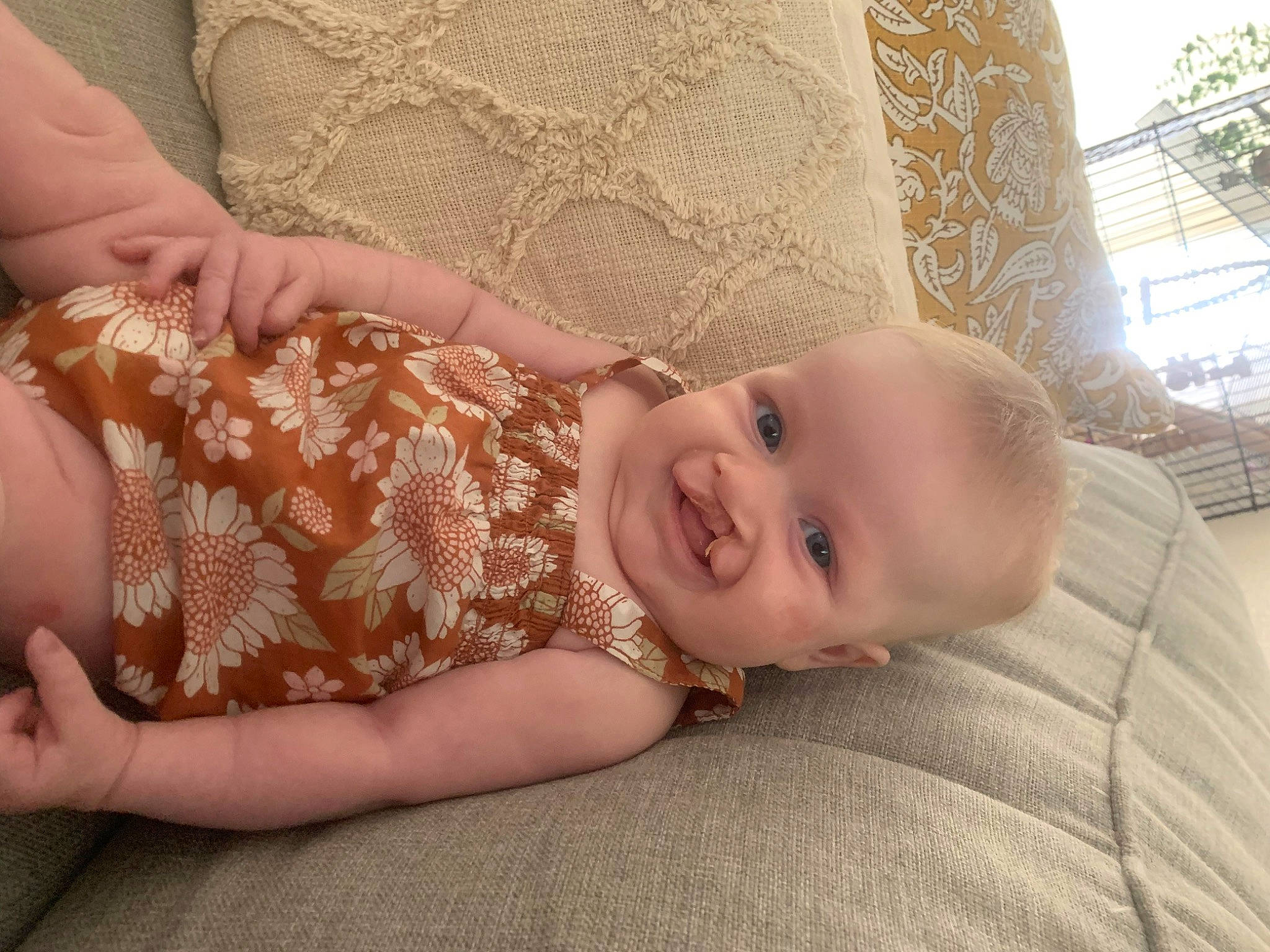 Lennon is registered to the contest to win money with this photo: baby, baby_toddler_clothing, comfort, dress, eye, finger, flooring, gesture, grass, happy, headgear, iris, joy, lip, nose, person, skin, sleeve, smile, toddler