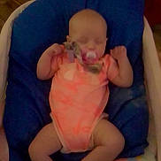 Sykora Tubbs joined the competition — help win amazing prizes! baby, infant, pacifier, sleeping, blue_cushion, orange_outfit, blanket, indoors, child, resting, cute, toddler, person, soft_lighting, baby_bed, sleep, small_arms, peaceful, clothing, head