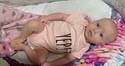 Sykora Tubbs joined the competition — help win amazing prizes! baby, infant, crib, blanket, pink_onesie, lying_down, colorful_blanket, indoors, child, person, cute, soft_lighting, sleeping_area, small_baby, newborn, resting, young_child, face, head, baby_clothing
