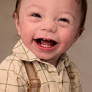 Skyler is registered to the contest to win money with this photo: toddler, smiling, child, happy, face, portrait, clothing, shirt, suspenders, cute, baby, young_child, studio, expression, innocence, person, fashion, hair, cheerful, closeup