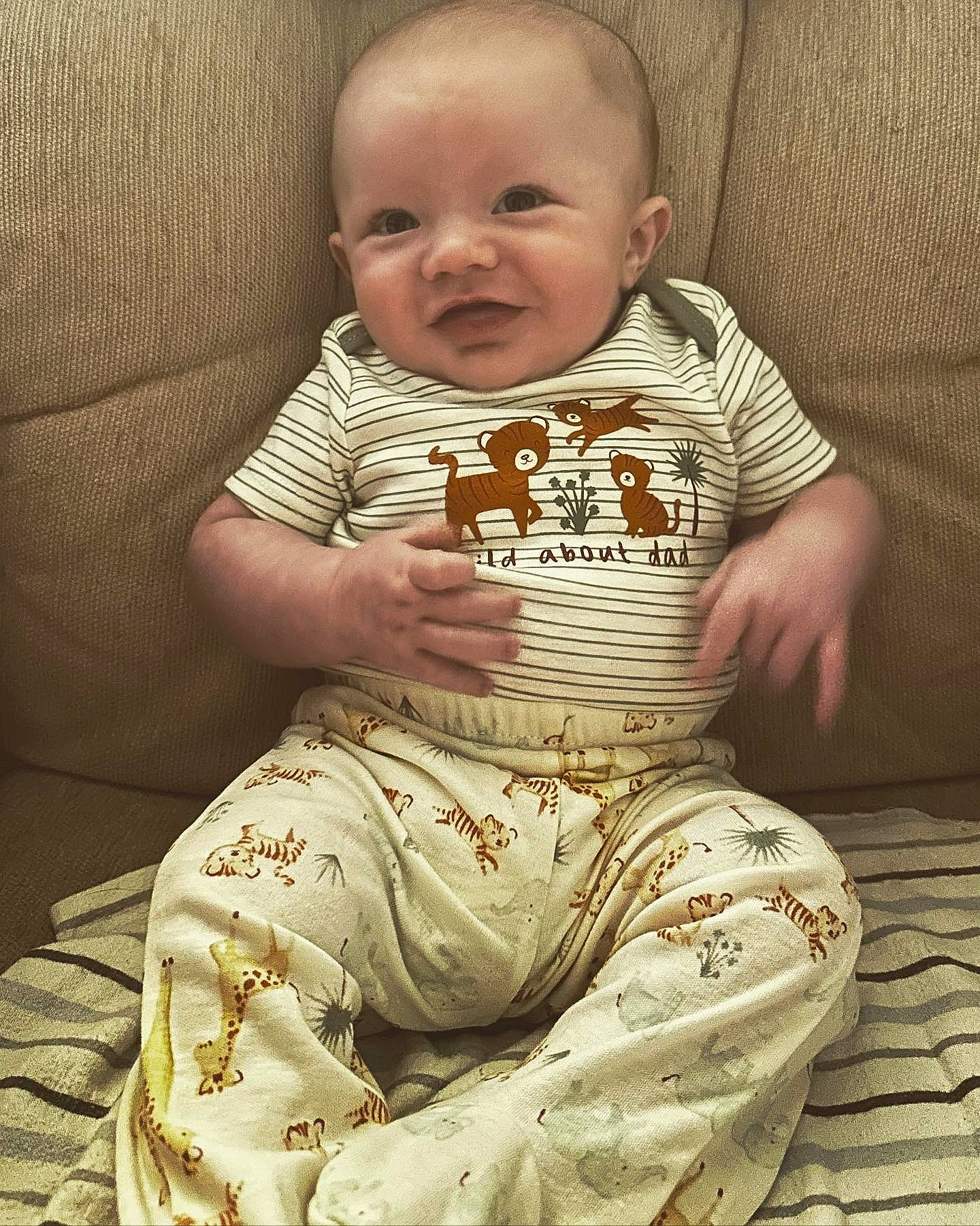 Benjamin is registered to the contest to win money with this photo: baby, baby_toddler_clothing, cheek, child, comfort, day_dress, embellishment, eye, happy, head, neck, one_piece_garment, pattern, peach, person, sitting, skin, sleeve, smile, t_shirt