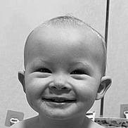 Grayson is registered to the contest to win money with this photo: baby, smiling, face, teeth, indoor, child, portrait, happy, head, skin, eyes, expression, cheeks, human, infant, cute, monochrome, closeup, messy, background