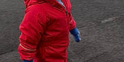 Grayson is registered to the contest to win money with this photo: child, toddler, red_snowsuit, winter_hat, blue_gloves, boots, outdoor, pavement, asphalt, cold_weather, walking, curious_expression, clothing, winter_clothing, street, young_child, knit_hat, playful, daylight, casual