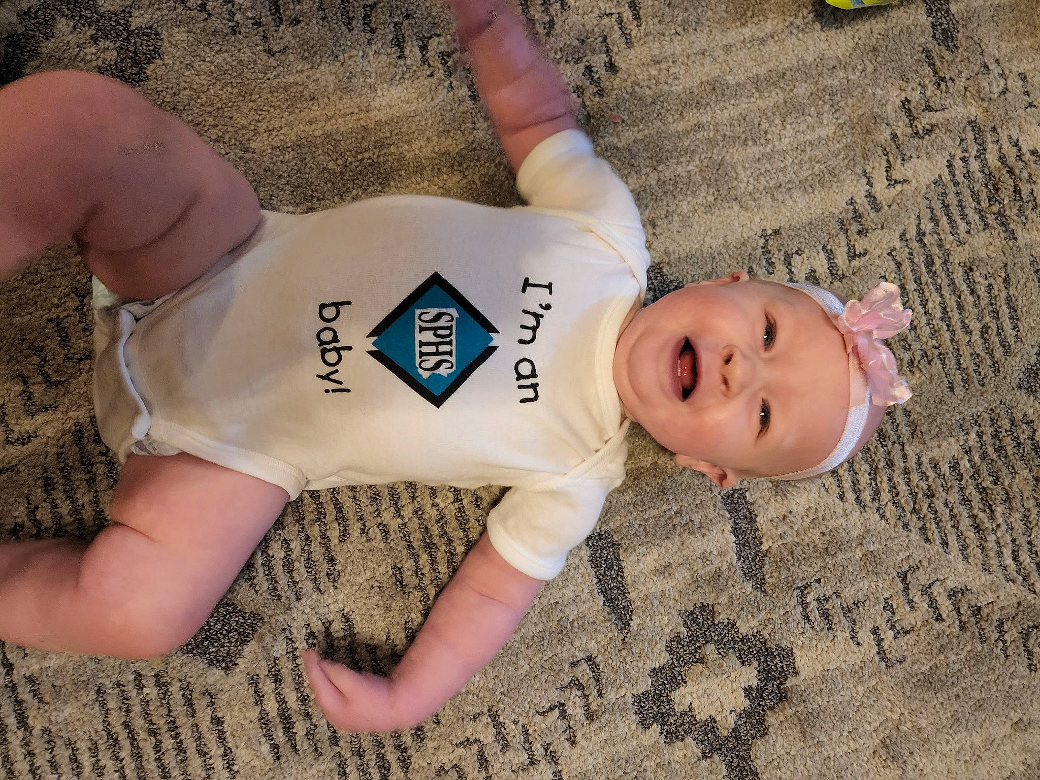 Baileigh is registered to the contest to win money with this photo: abdomen, chest, elbow, eye, flooring, fun, grass, happy, headgear, headwear, human_body, human_leg, joint, knee, person, skin, smile, thigh, toddler, trunk