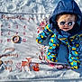 baby, blanket, child, deer_illustration, fox_illustration, hood, milestone_blanket, numbers, outdoor, owl_illustration, portrait, ring, shadow, smile, snow, snowsuit, sunglasses, sunlight, toy, winter