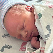 Skye is registered to the contest to win money with this photo: newborn, baby, sleeping, blanket, hat, swaddled, infant, closeup, face, peaceful, cute, cozy, hand, soft, indoors, portrait, child, resting, skin, newborn_baby