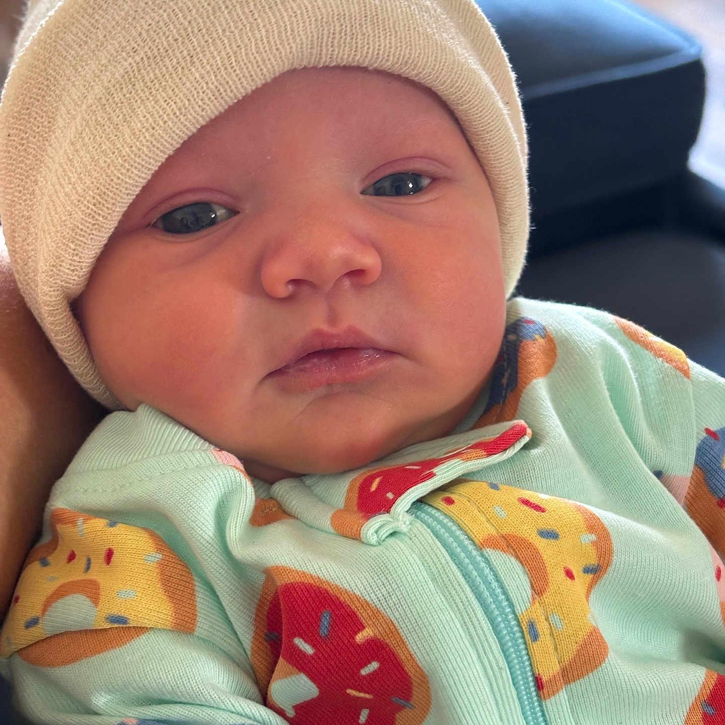 Skye joined the competition — help win amazing prizes! apparel, baby, child, closeup, clothing, cute, donut_pattern, expression, face, hat, indoor, infant, knit_hat, newborn, onesie, person, portrait, skin, soft_light, young