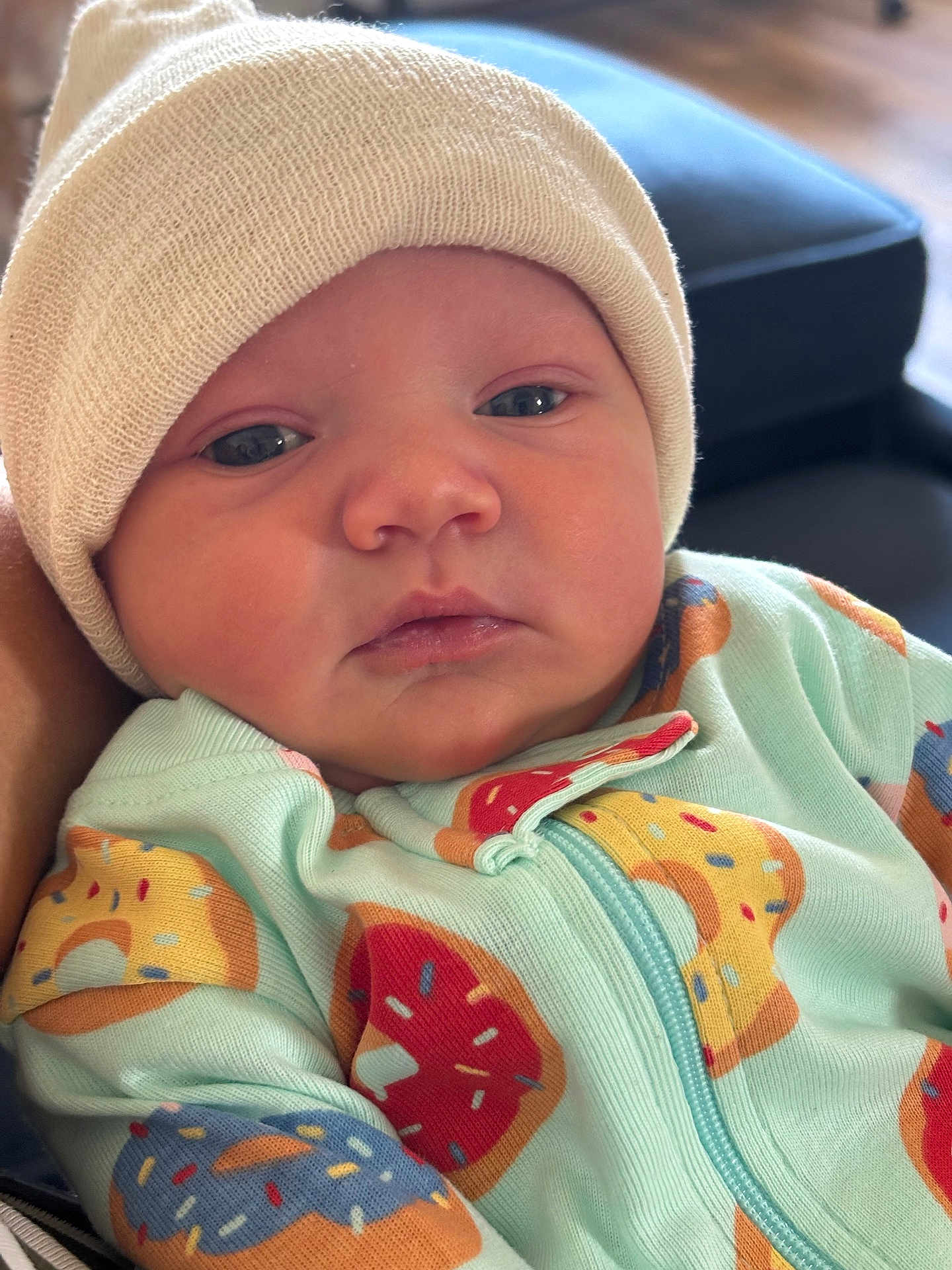 Skye joined the competition — help win amazing prizes! baby, infant, face, hat, knit_hat, clothing, onesie, donut_pattern, closeup, portrait, cute, child, young, indoor, soft_light, skin, expression, newborn, person, apparel