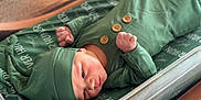 Skye joined the competition — help win amazing prizes! baby, newborn, infant, green_clothing, hat, blanket, fist, lying_down, bed, wooden_frame, face, skin, cute, sleepwear, portrait, small_hands, baby_bed, soft_fabric, peaceful, indoors