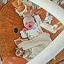 baby, newborn, yawning, blanket, plush_toy, lion, baby_gym, soft_toy, sleepwear, hat, infant, cozy, play_mat, cute, child, indoors, resting, wrapped, peaceful, nursery
