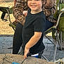 Mateo joined the competition — help win amazing prizes! child, smiling, boy, plaid_shirt, woman, baby, outdoor, fire_pit, folding_chair, stone, face, person, hair, laughter, family, casual_clothing, nature, daylight, happy, playful