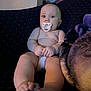 Maddox is registered to the contest to win money with this photo: baby, infant, pacifier, diaper, couch, blanket, feet, hands, face, skin, indoor, child, expression, seated, curious, plush, comfort, cozy, human, portrait