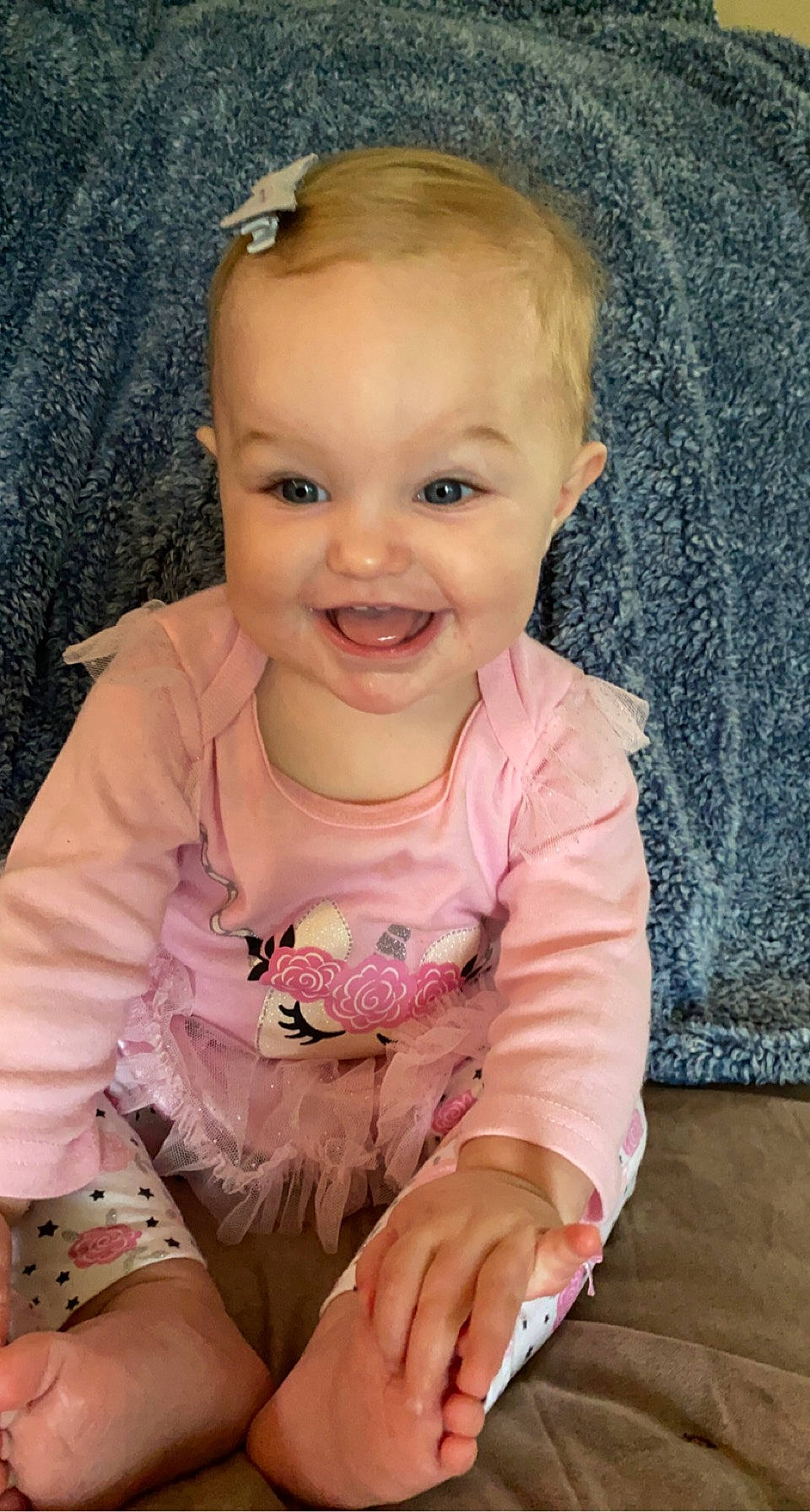 Aisley is registered to the contest to win money with this photo: baby, blond, cheek, child, child_model, ear, eye, face, facial_expression, finger, head, iris, joy, lip, mouth, nose, person, pink, sitting, skin