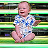 Lukas joined the competition — help win amazing prizes! baby, child, smiling, sitting, shirt, starfish_pattern, bench, neon_lights, happy, cute, blue_eyes, short_sleeves, infant, indoors, colorful, legs_crossed, person, portrait, bright, casual_clothing