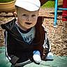 toddler, child, cap, jacket, playground, slide, outdoor, smiling, sunny, toy, green, play_equipment, person, casual_clothing, daylight, happy, park, recreation, baby, fun