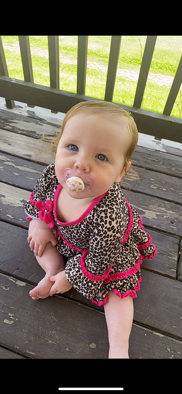 Mila joined the competition — help win amazing prizes! baby, baby_toddler_clothing, cheek, child, face, fence, foot, fun, grass, green, happy, leisure, lip, nail, pattern, person, pink, sitting, skin, sleeve