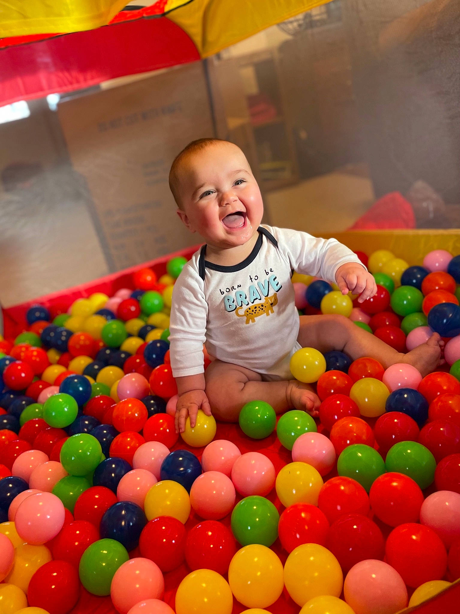 Peter is registered to the contest to win money with this photo: baby, ball, ball_pit, child, fun, happy, human_settlement, leisure, light, people, person, photograph, playground, product, recreation, red, smile, snapshot, t_shirt, toddler