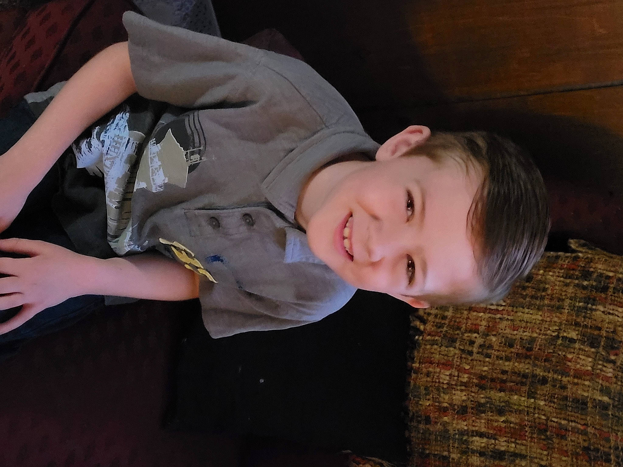 Liam is registered to the contest to win money with this photo: baby_laughing, baby_toddler_clothing, cheek, child, comfort, elbow, flash_photography, fun, gesture, grass, happy, human_leg, joy, person, portrait_photography, sitting, sleeve, smile, toddler, tree