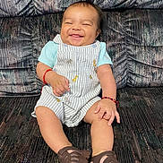 Daniel Alvizures joined the competition — help win amazing prizes! baby, child, smiling, sitting, romper, sandals, couch, furniture, happy, cute, patterned, indoor, portrait, infant, clothing, bracelet, person, footwear, face, young