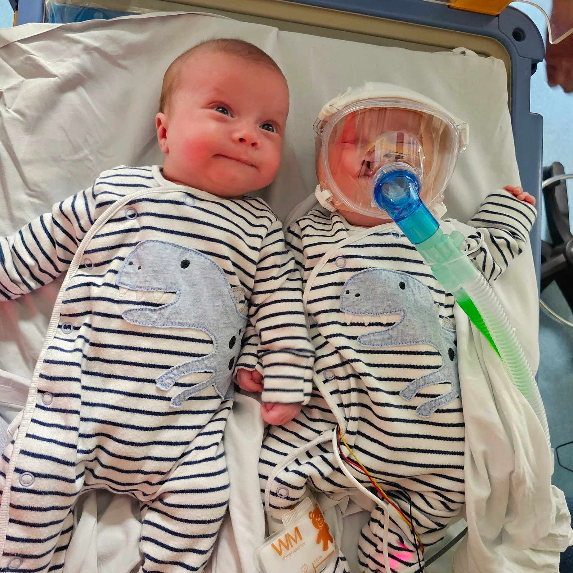 Freddie And Easton is registered to the contest to win money with this photo: architecture, baby, bed, bodypart, building, clinic, clothing, crib, face, finger, furniture, hand, head, hospital, infantbed, newborn, person, photography, portrait, t_shirt