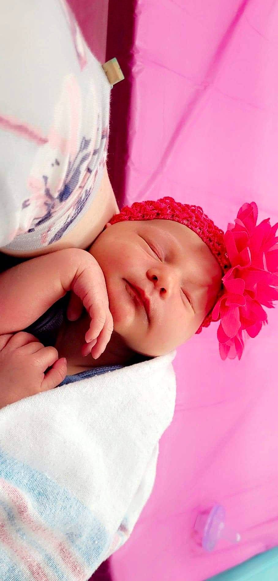 Evelyn is registered to the contest to win money with this photo: baby, baby_sleeping, baby_toddler_clothing, cheek, child, comfort, eyelash, fashion_accessory, finger, flower, gesture, happy, headwear, linens, lip, magenta, person, petal, pink, skin