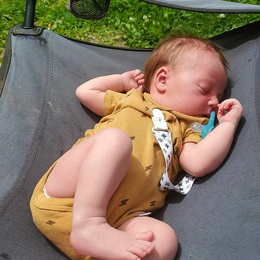 Oaklyn is registered to the contest to win money with this photo: baby, bodypart, face, finger, furniture, grass, hand, head, lawn, nature, newborn, outdoors, park, person, photography, plant, playarea, portrait, sleeping, summer