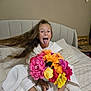 barefoot, bed, blanket, child, colorful, cozy, flower_bouquet, furniture, happy, home, indoor, long_hair, person, pillow, playful, portrait, sitting, smiling, tongue_out, white_robe