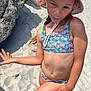 Lya a rejoint le concours — aidez-le/la à gagner de superbes lots ! barefoot, beach, child, colorful, girl, hat, nature, ocean, outdoor, person, playful, portrait, posing, rocks, sand, summer, sunlight, sunny, swimsuit, vacation
