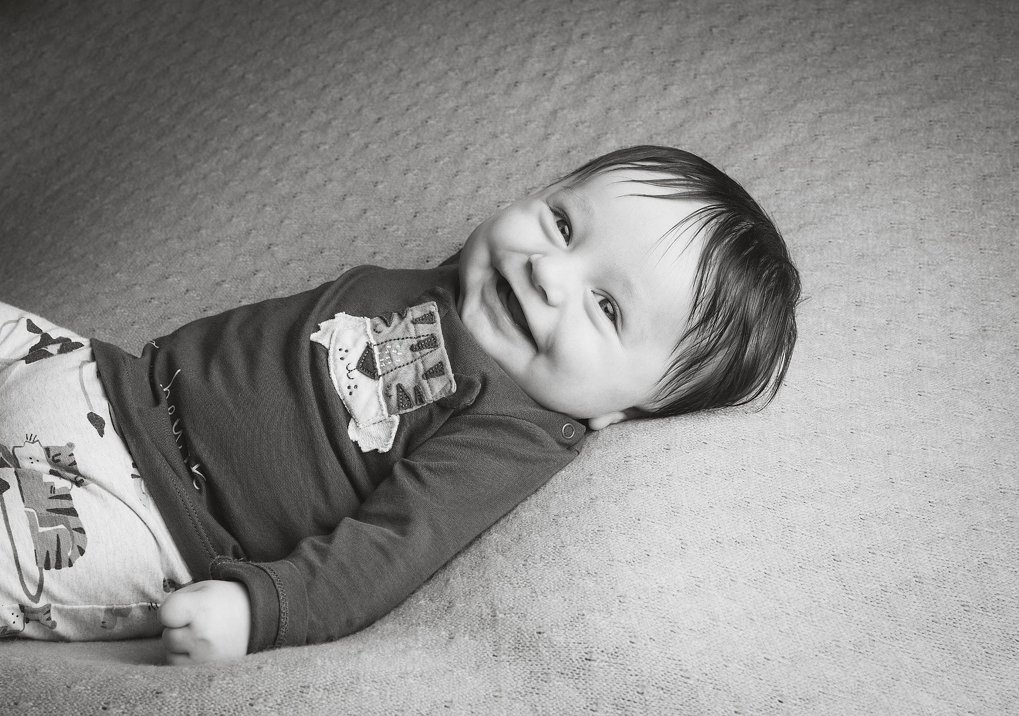 Bertie is registered to the contest to win money with this photo: black_and_white, child, comfort, elbow, eye, flash_photography, flooring, fun, grey, happy, head, human_leg, joy, monochrome, monochrome_photography, person, portrait_photography, sitting, sleeve, smile