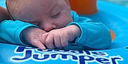 Justin is registered to the contest to win money with this photo: baby, sleeping, inflatable, pool, water, blue, orange, child, float, relaxing, peaceful, infant, closeup, soft_focus, summer, outdoor, calm, hands, face, head