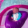 Justin is registered to the contest to win money with this photo: baby, sleeping, floatation_device, pool, water, purple, pink, blue, infant, child, relaxation, sunlight, outdoor, swimming_pool, resting, cute, soft, calm, summer, comfort