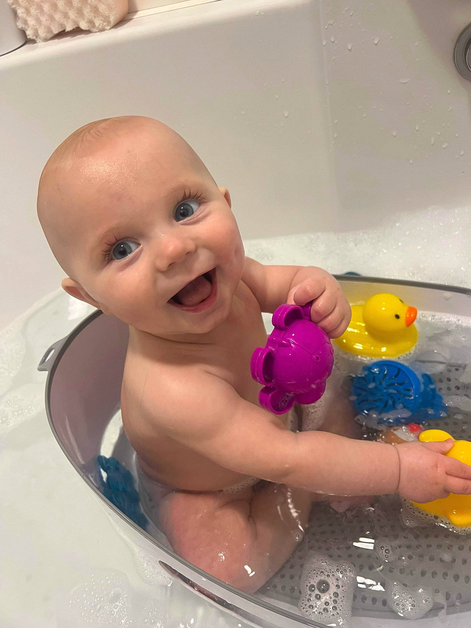 Noah is registered to the contest to win money with this photo: baby, baby_bathing, bath_toy, bathing, bathroom, bathtub, cheek, child, computer_keyboard, facial_expression, fluid, fun, happy, leisure, liquid, person, plumbing, skin, smile, toddler