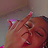 Iyanna joined the competition — help win amazing prizes! casual, ceiling, closed_eyes, earrings, face, female, gesture, hand, happy, indoor, long_nails, music_overlay, person, pink_clothing, portrait, selfie, smile, text_overlay, wall, young_adult
