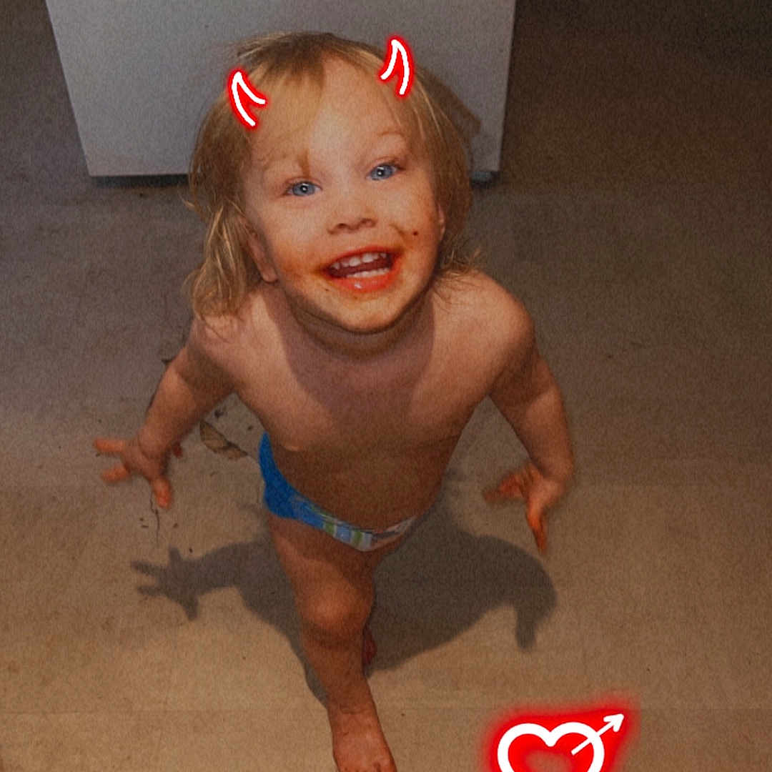 Jaxson is registered to the contest to win money with this photo: accessories, baby, barefoot, clothing, costume, diaper, face, happy, head, heart, indoors, jewelry, laughing, necklace, person, photography, portrait, shorts, swimwear, text