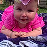 baby, child, pink_clothing, flower_headband, blanket, outdoor, grass, smiling, portrait, headwear, cute, infant, happy, toddler, closeup, nature, person, baby_girl, head, playful