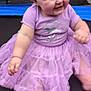 Arya joined the competition — help win amazing prizes! apparel, baby, child, cute, dress, face, foot, hand, happy, infant, joyful, outdoor, person, playful, purple, sitting, smiling, trampoline, tutu, young