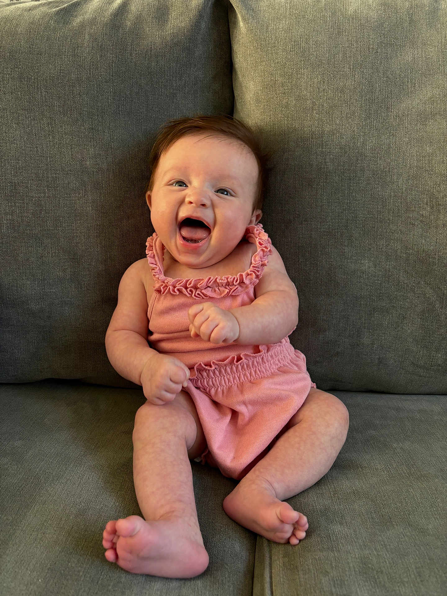 Maya joined the competition — help win amazing prizes! baby, infant, smiling, happy, pink_outfit, sitting, couch, furniture, indoor, child, cute, human, portrait, skin, feet, hands, expression, young, one_person, casual_clothing