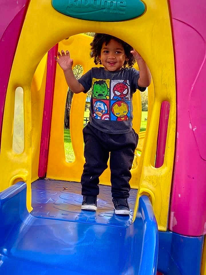 Kendrick is registered to the contest to win money with this photo: automotive_tire, blue, child, electric_blue, fun, green, inflatable, joy, leisure, outdoor_play_equipment, person, photograph, playground, product, public_space, purple, recreation, smile, snapshot, t_shirt